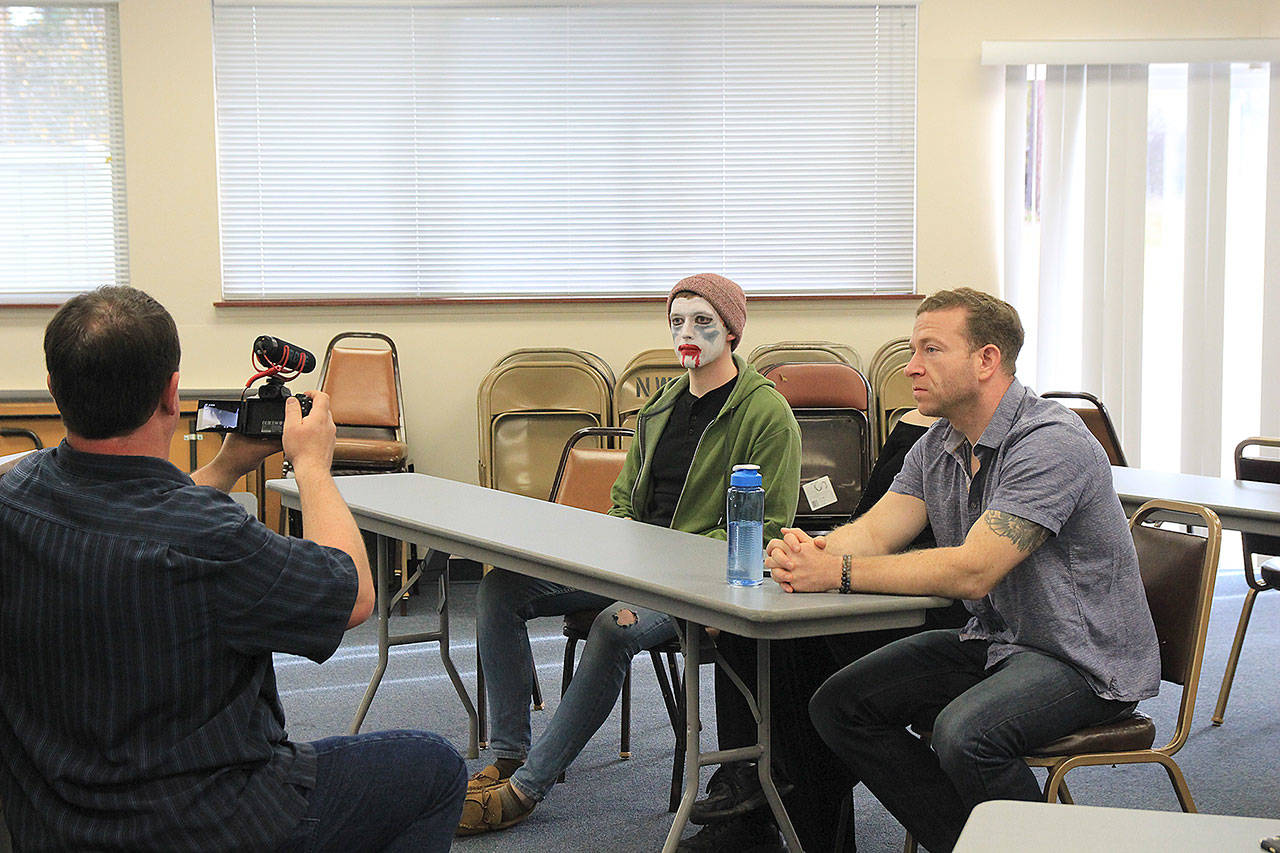 Jason Blaszkowski shoots a scene of “Scared Stiff” with Jared Maybury, left, and Patrick Cain. Photo by Laura Guido/Whidbey News-Times