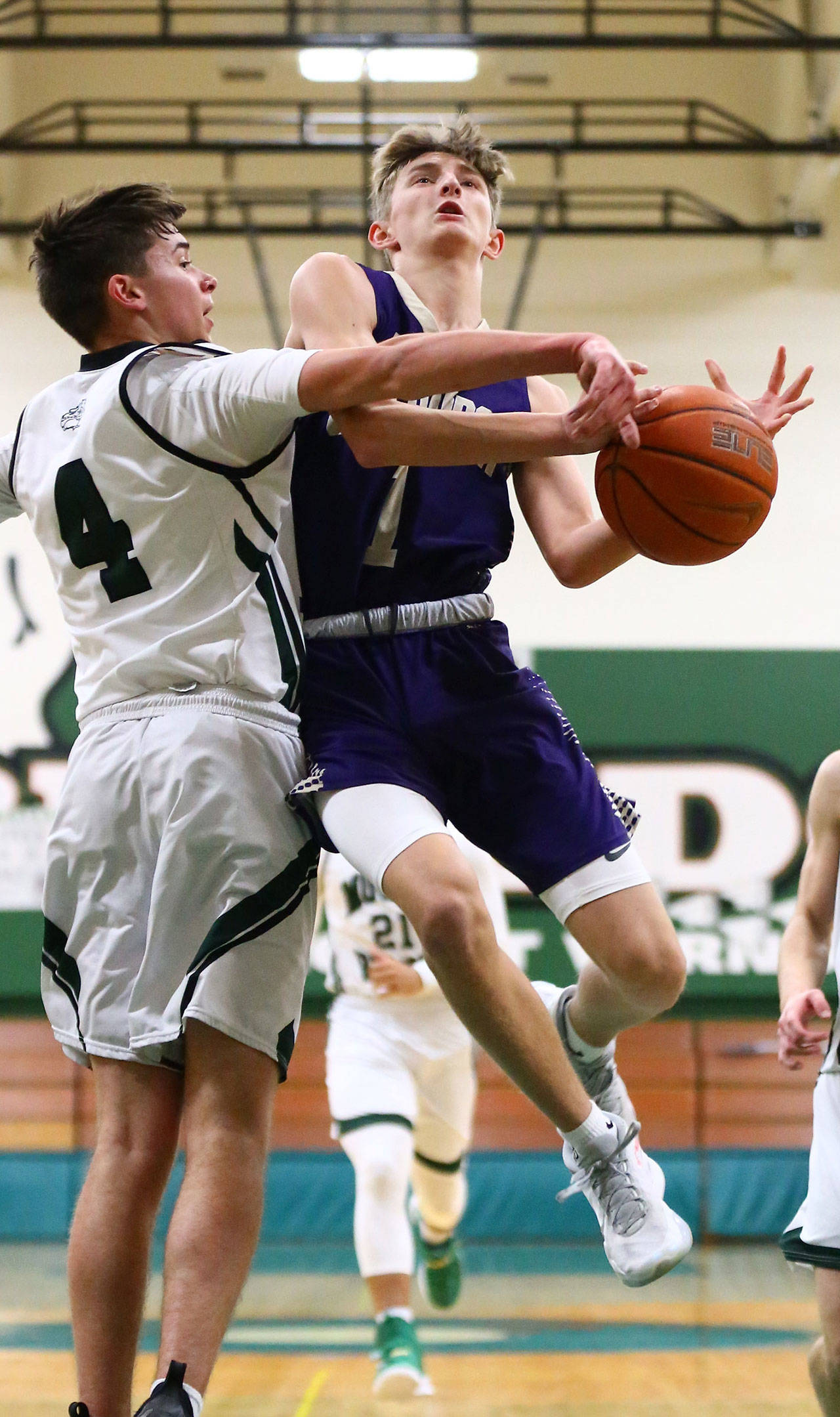 Oak Harbor’s Brock Boyer (1) is defended by Mount Vernon’s Cain Cress. (Photo by John Fisken)