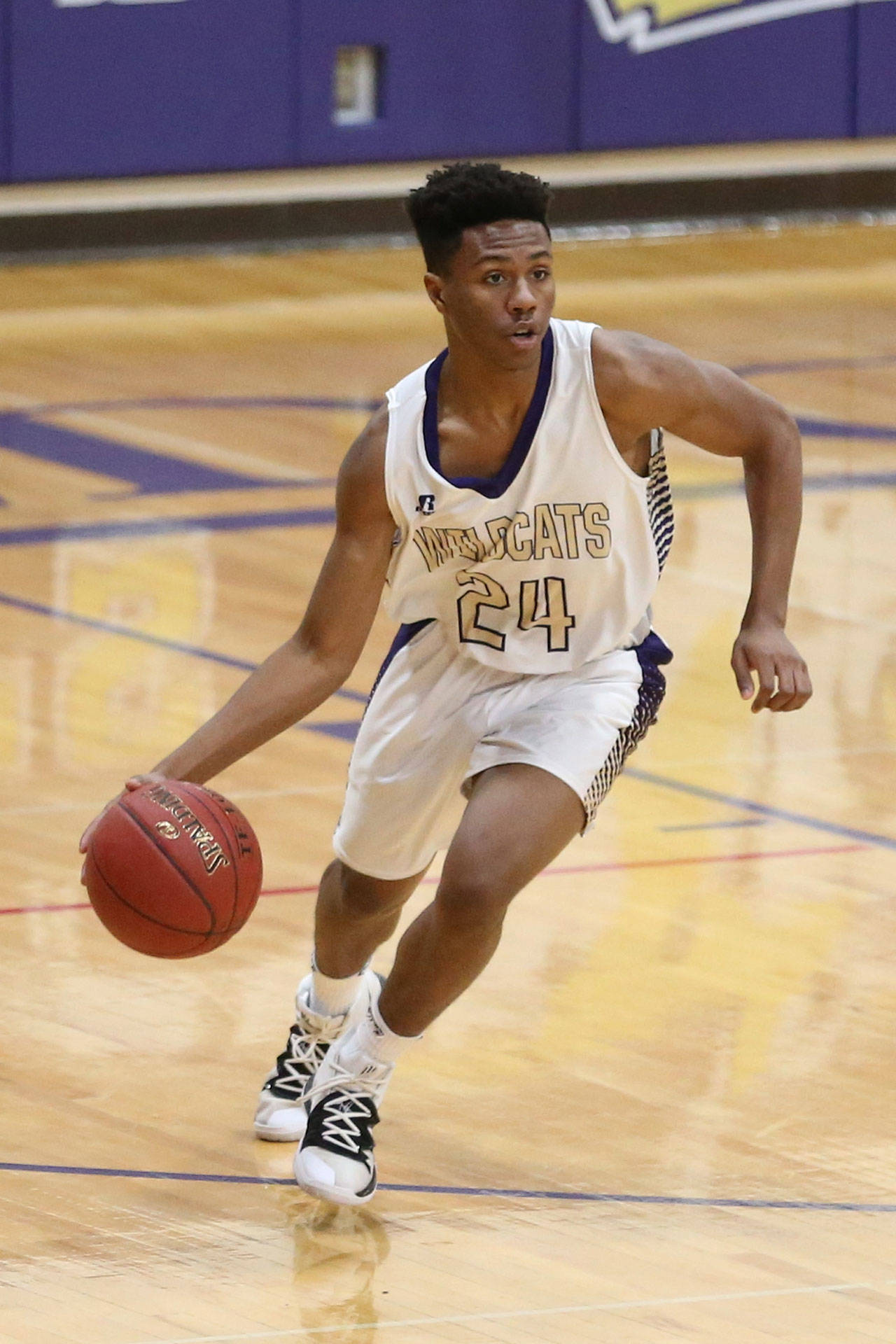 Izayah Jannini brings the ball up the floor for the Wildcats.(Photo by John Fisken)