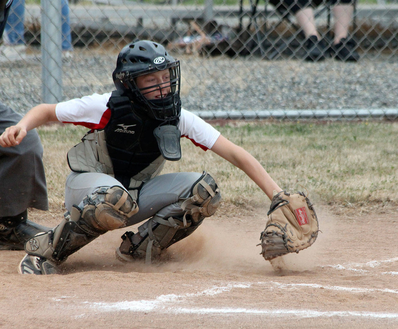 Catcher Chase Anderson scoops up a low pitch against Anacortes. (Photo by Jim Waller/Whidbey News-Times)