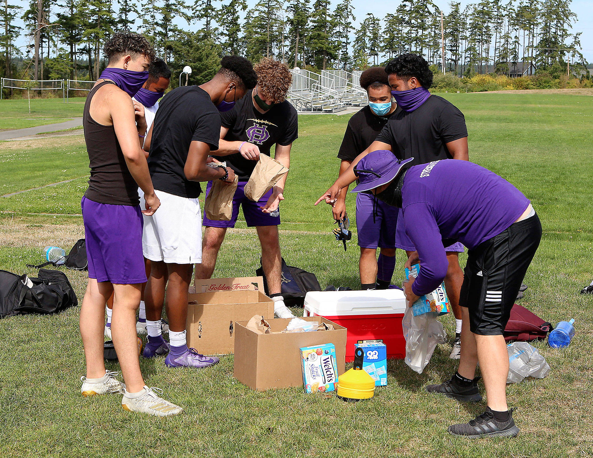 Oak Harbor athletes take advantage of the Whidbey AthlEATS program after a workout at Fort Nugent Park Wednesday. (Photo by John Fisken)