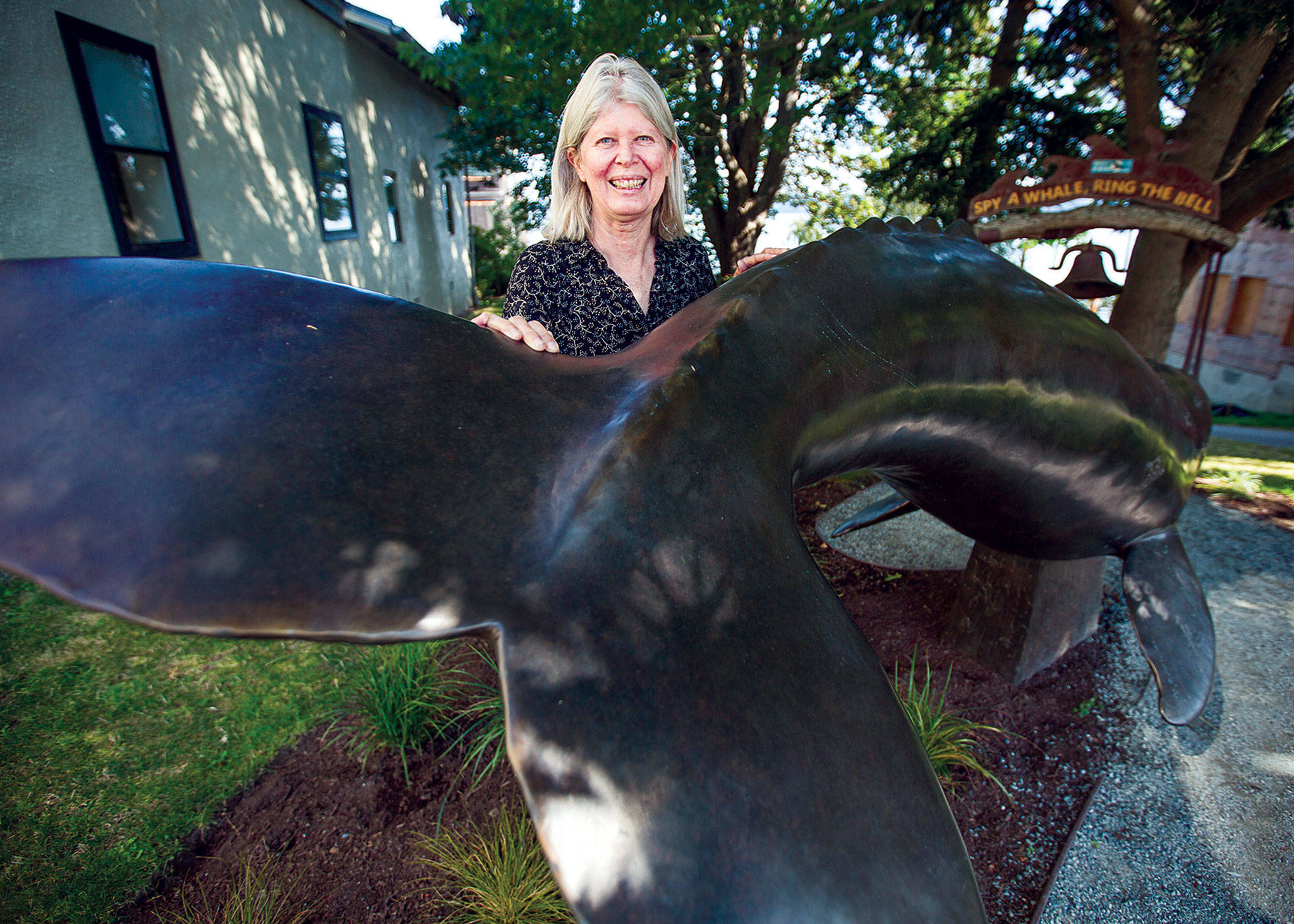 Photo by Olivia Vanni/The Herald
Georgia Gerber with her whale statue on display along First Street in Langley.