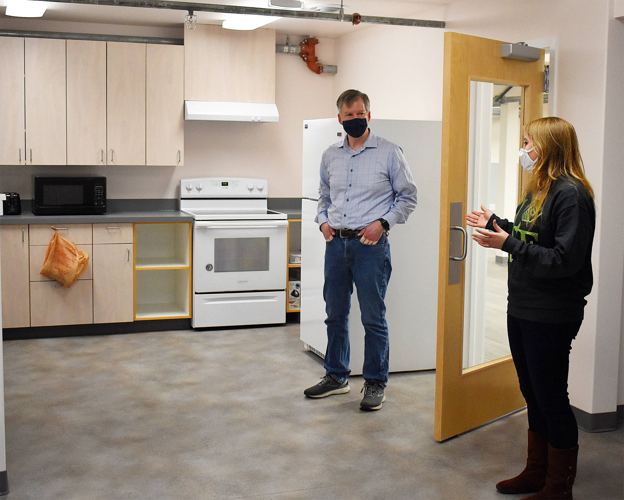 State Rep. Dave Paul, D-Oak Harbor, talks to Boys and Girls Club of Oak Harbor Unit Director Nikki Barone about some of the new ways the club will be able to teach kids kitchen skills in its new building on Ely Street. Photo by Emily Gilbert/Whidbey News-Times