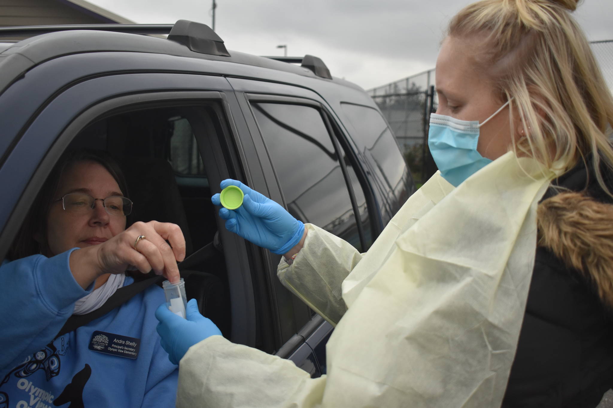 School nurse Julie Vandergrifft collects a COVID-19 test from Olympic View Elementary school principal’s secretary Andra Shelley during voluntary weekly testing on Wednesday, Jan. 20. Photo by Emily Gilbert/Whidbey News-Times