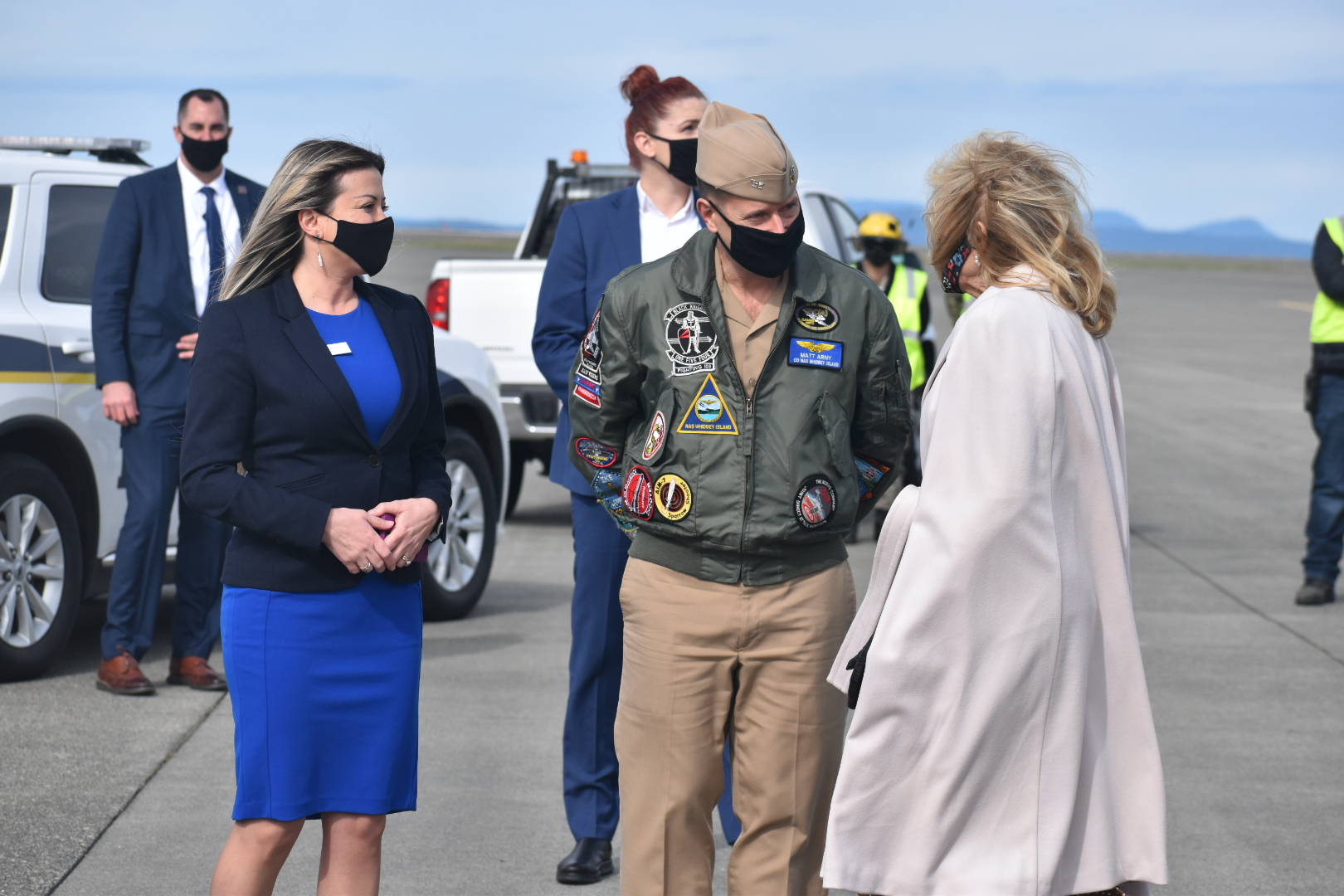 Capt. Matthew Arny, middle, and his wife Samar, left, greet first lady Jill Biden during her visit in March. Arny told Oak Harbor City Council members he will be leaving Naval Air Station Whidbey Island in July. (Photo by Emily Gilbert/Whidbey News-Times)