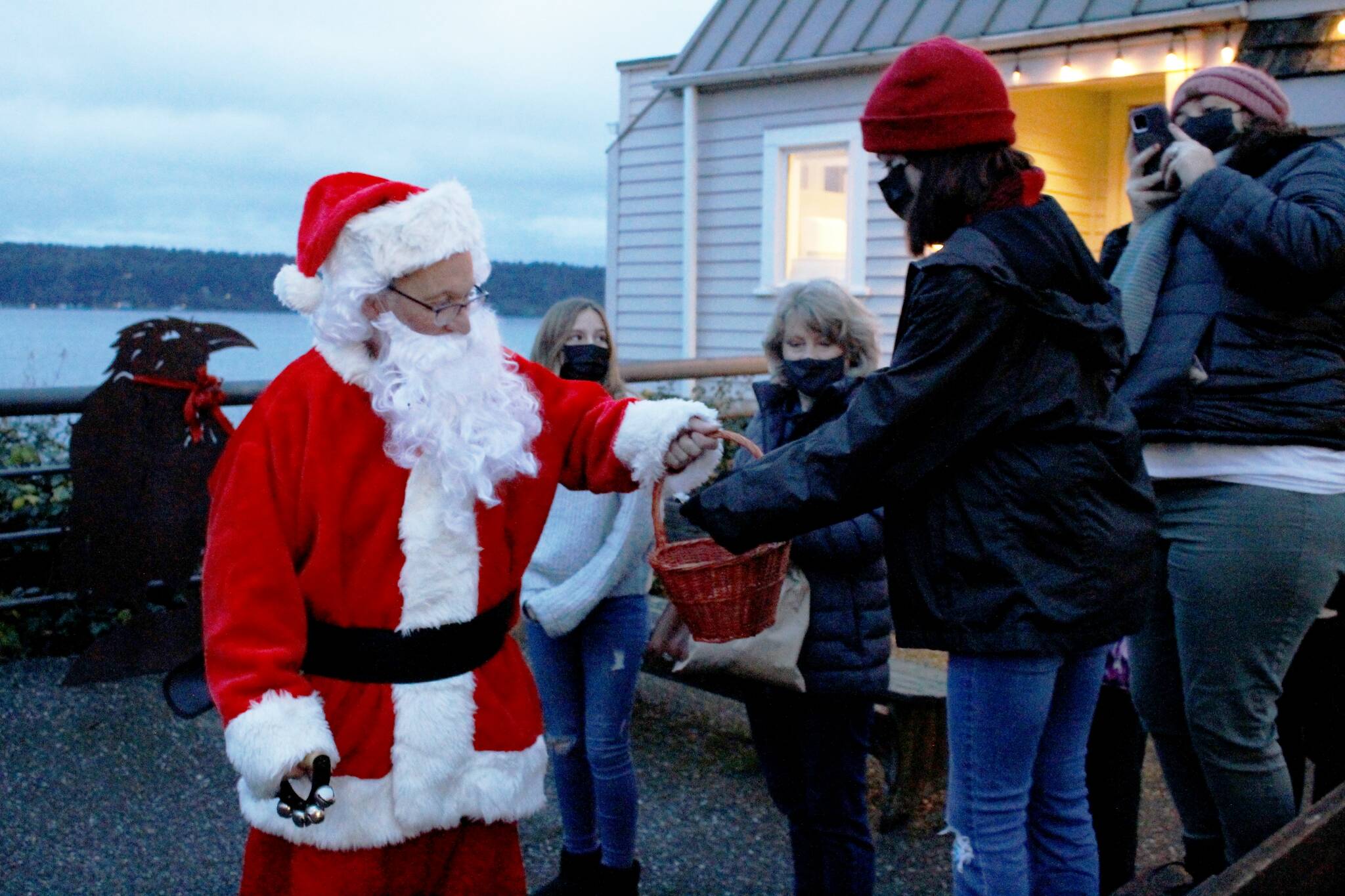 Photo by Kira Erickson/South Whidbey Record
Santa Claus, played this year by Mark Stewart Cassidy, handed out gobs of candy canes to a crowd of children Saturday evening in Langley during the city’s annual Tree Lighting Ceremony. The big jolly red man traveled to three different Christmas trees in the Village by the Sea’s downtown corridor.