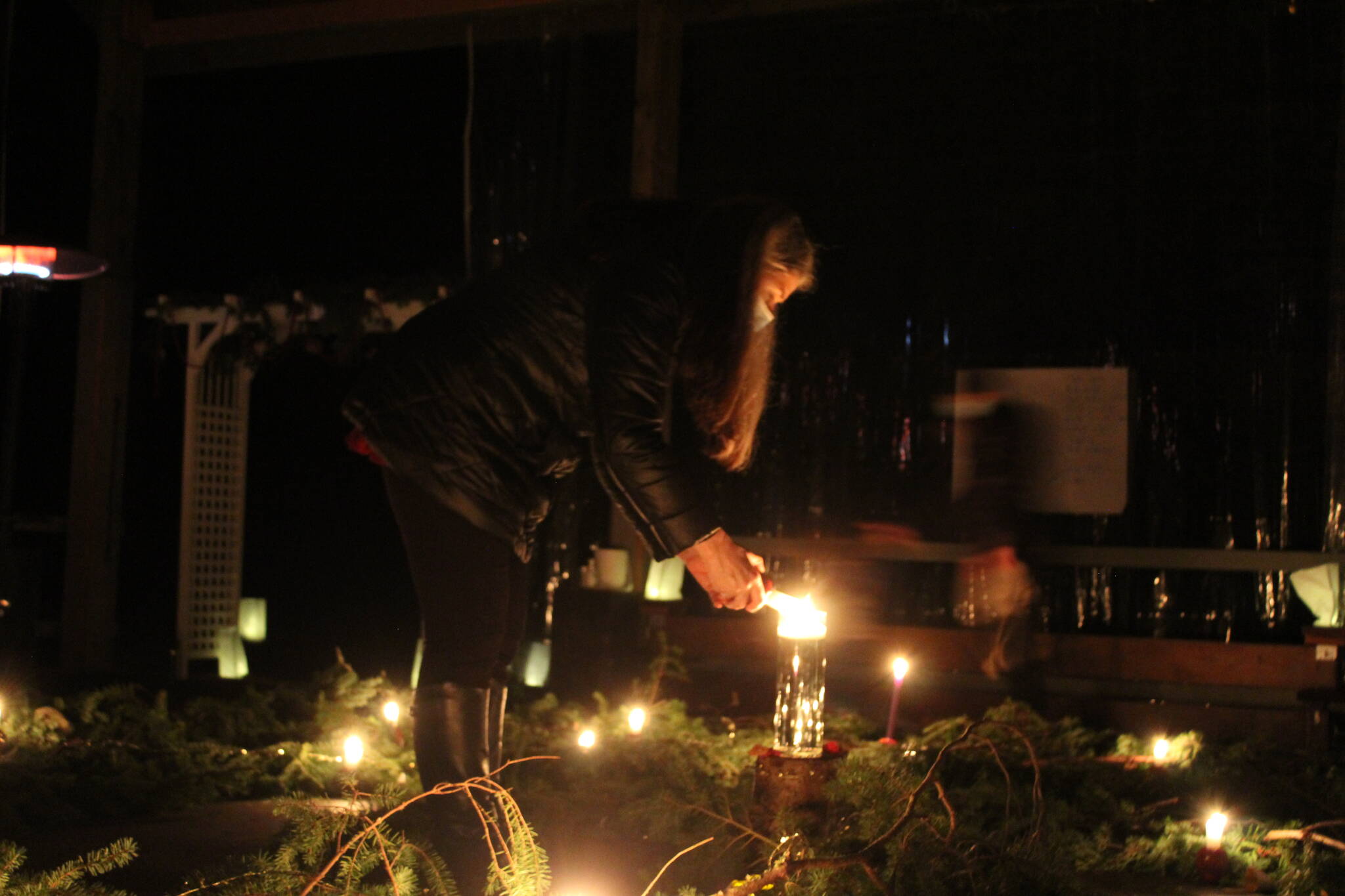 Photo by Karina Andrew/Whidbey News-Times
Visitors light their candles in the center of the spiral.