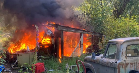 A storage shed and travel trailer were completely destroyed in a fire June 25. (Photo by South Whidbey Fire/EMS)