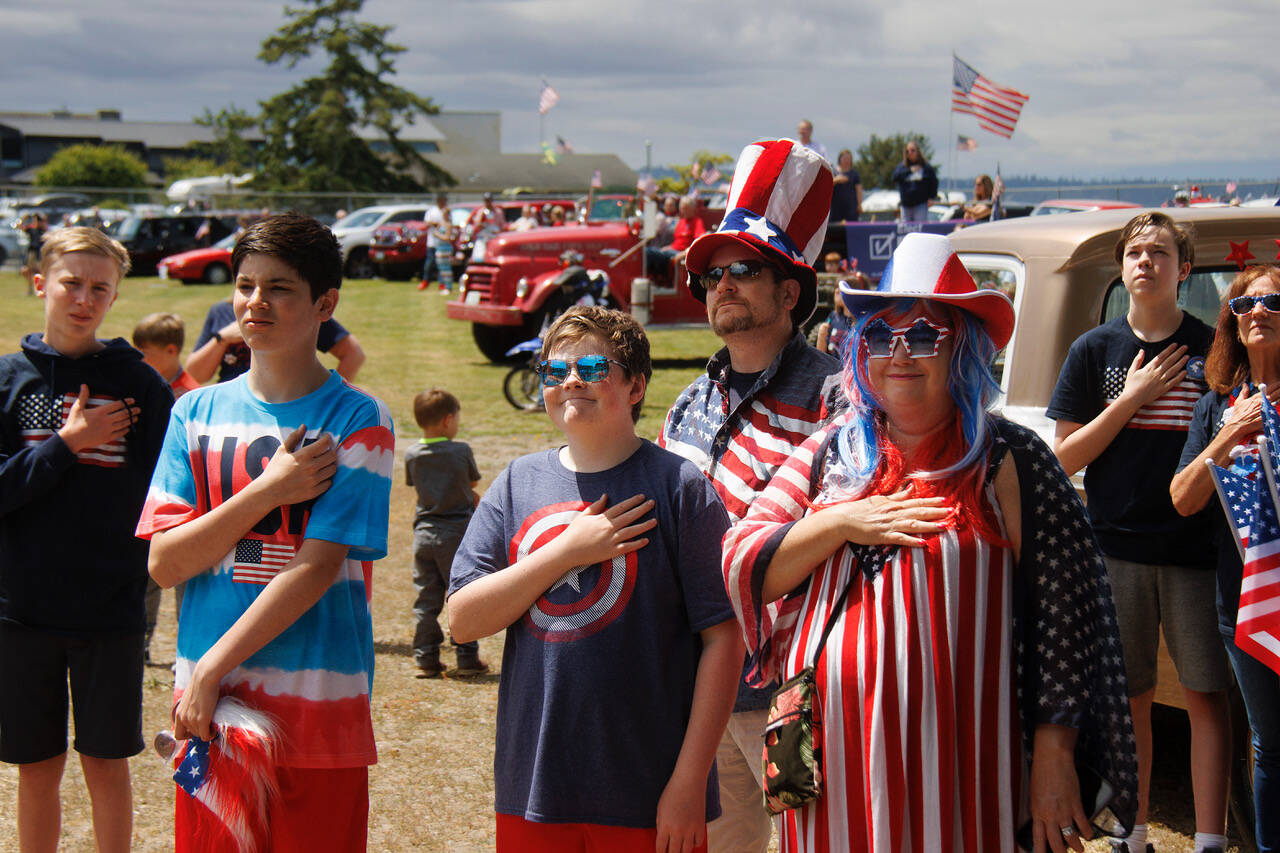 Maxwelton parade-goers pause for the National Anthem.