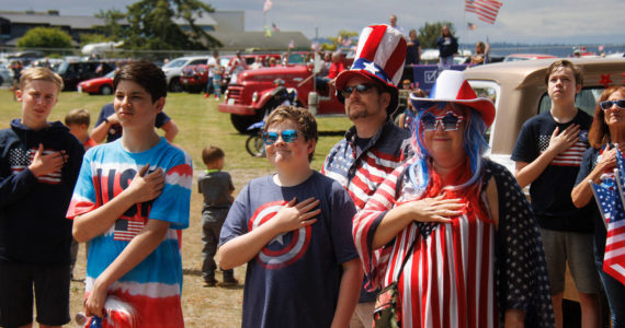 By David Welton
Maxelton parade-goers pause for the National  Anthem.