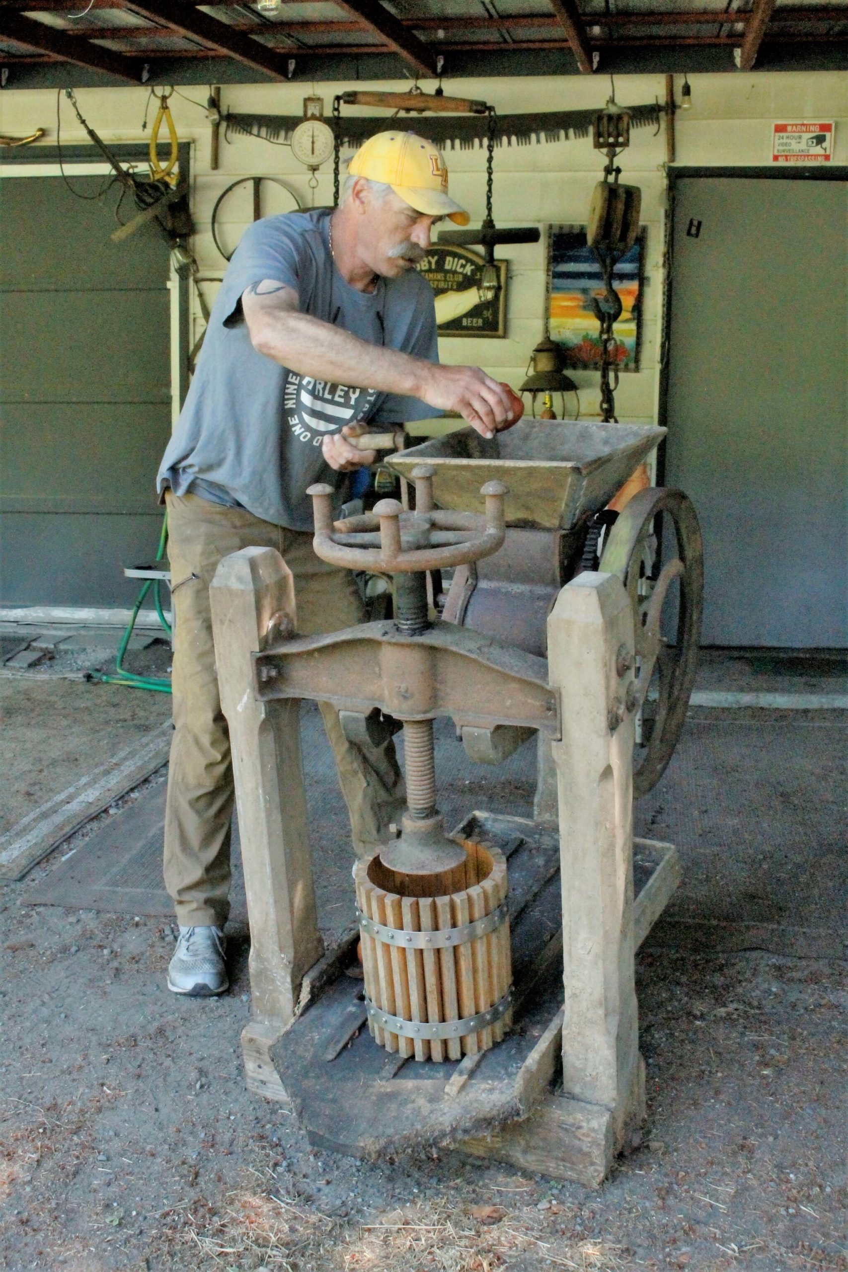 Photo by Kira Erickson/South Whidbey Record
South Whidbey “picker” John Norris demonstrates how to use an old fruit press he found while exploring a family farm. He has plans to donate the artifact to the South Whidbey Historical Society, which will put it on display for fairgoers to see this year.