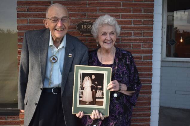 Eugene “Dud” Gilbert and Dorothy Gilbert pose for a photo just steps away from where they first met in downtown Oak Harbor 70 years ago. Photo by Emily Gilbert