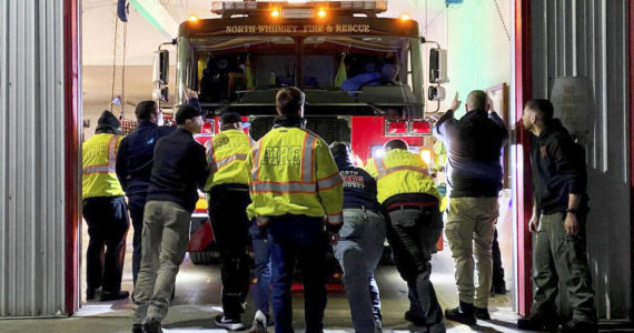 Photo provided
North Whidbey Fire and Rescue firefighters push one of two new engines into its new home at Station 25.