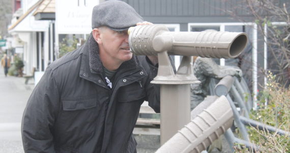 Photo by Kira Erickson/South Whidbey Record
Callahan McVay peers through a telescope on First Street in Langley. During the pandemic, the Langley Main Street Association installed the telescopes, which make for great whale-watching opportunities.