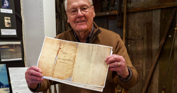 Photo by David Welton
South Whidbey Historical Society President William Haroldson proudly holds a paper copy of Whidbey’s will. He has been studying Whidbey’s life for the past 20 years, and even brought back a reprint of a portrait of the naval explorer from England in 2003.