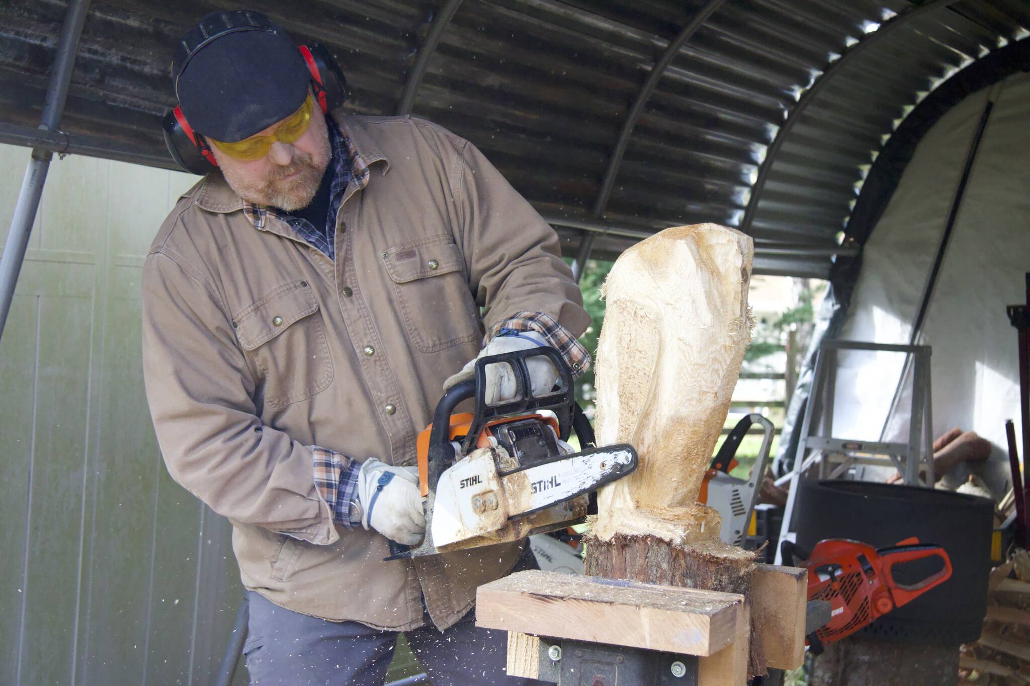 Photo by Rachel Rosen
Ted Boesch carves an owl sculpture.