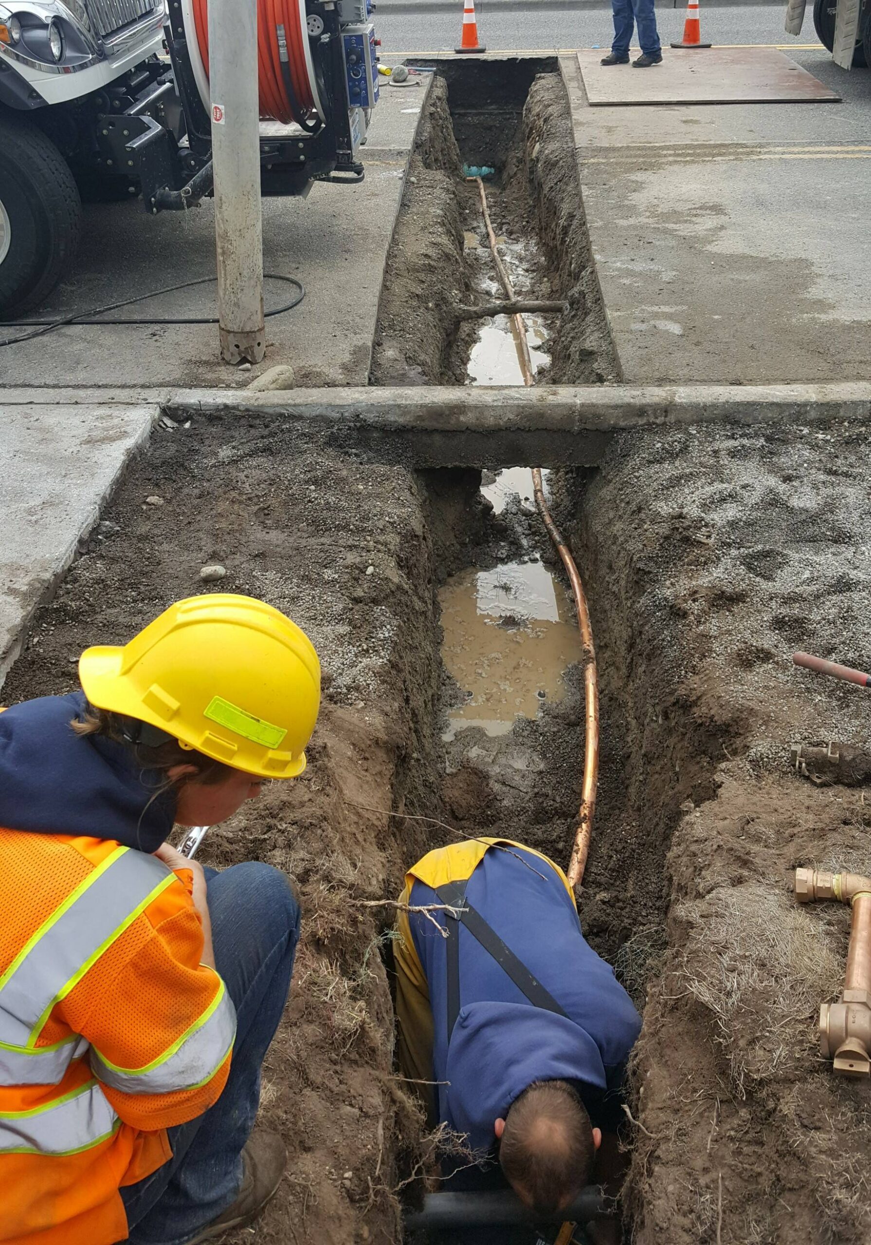 Public works crew members fix a leaky water main on Barrington Drive. (Photo provided)