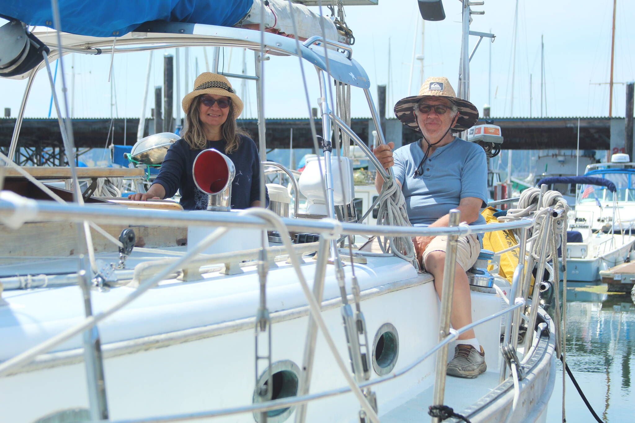 From left, Jackie and Jeffrey Baraban enjoy a sunny day on their boat at the Oak Harbor Marina. The Barabans are among those marina patrons who would consider relocating if moorage rates spike too high. (Photo by Karina Andrew/Whidbey News-Times)