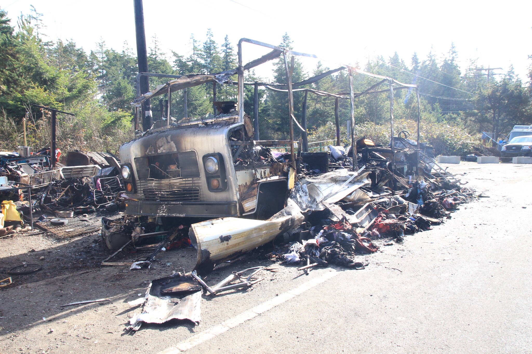 An RV was destroyed in a fire Sunday at a roadside homeless encampment. (Photo by Luisa Loi / Whidbey News-Times)