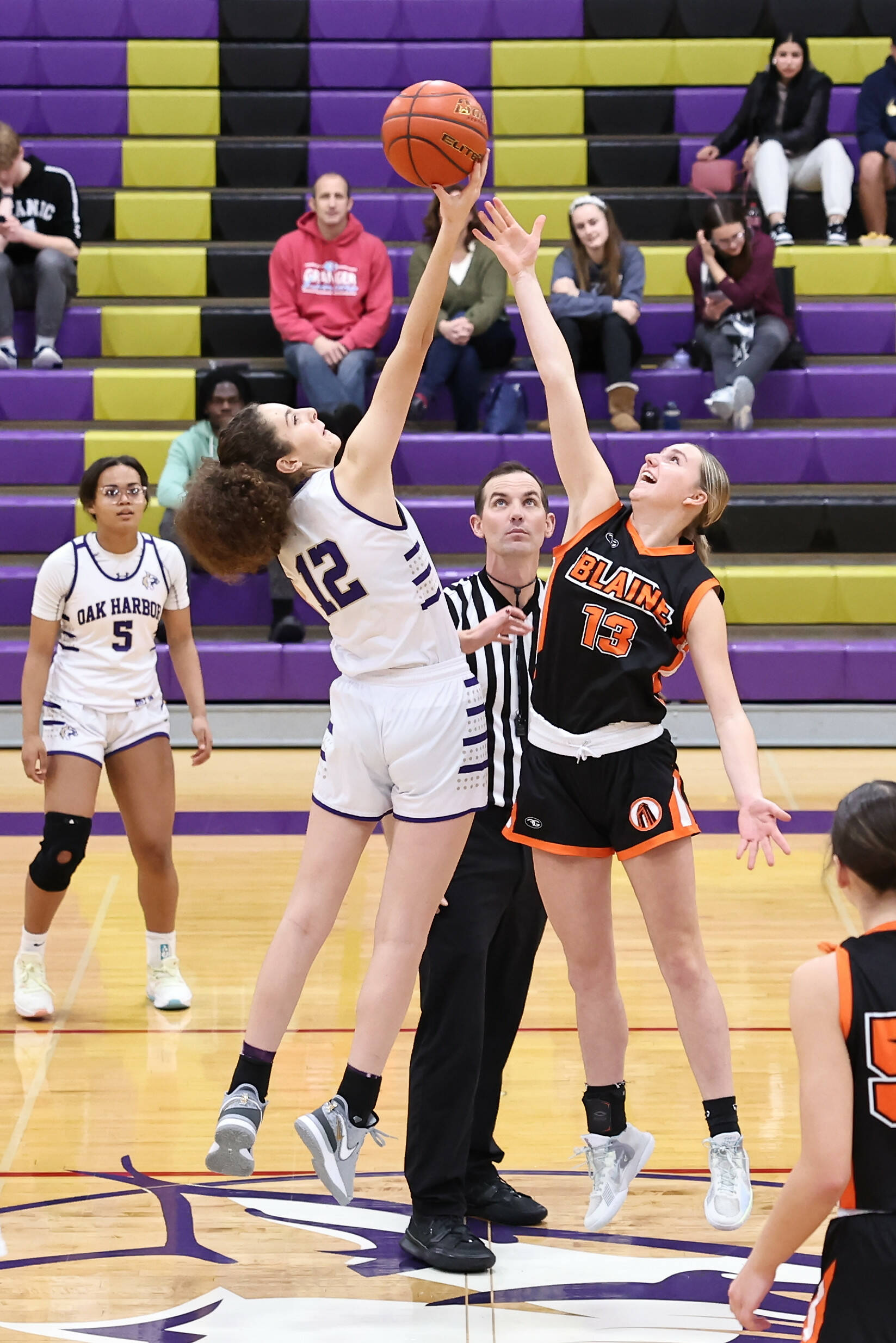 Oak Harbor High School senior AJ White tips the ball during the Wildcats first home game of the season Dec. 9. Oak Harbor won 54-51. (Photo by John Fisken)