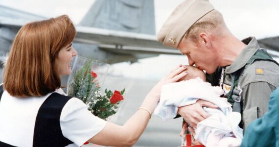 Randy Pierson meeting Alyssa, 1 month old, for the first time during the VAQ-137 Rooks Homecoming in 1998. (Photo Provided)