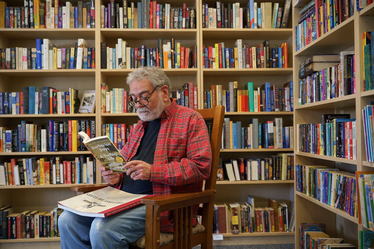 Photo by David Welton
Bob Markey reads from “Barbarian Days: A Surfing Life” by William Finnegan. It’s one of many titles within his new bookstore, Mutiny Bay Books.