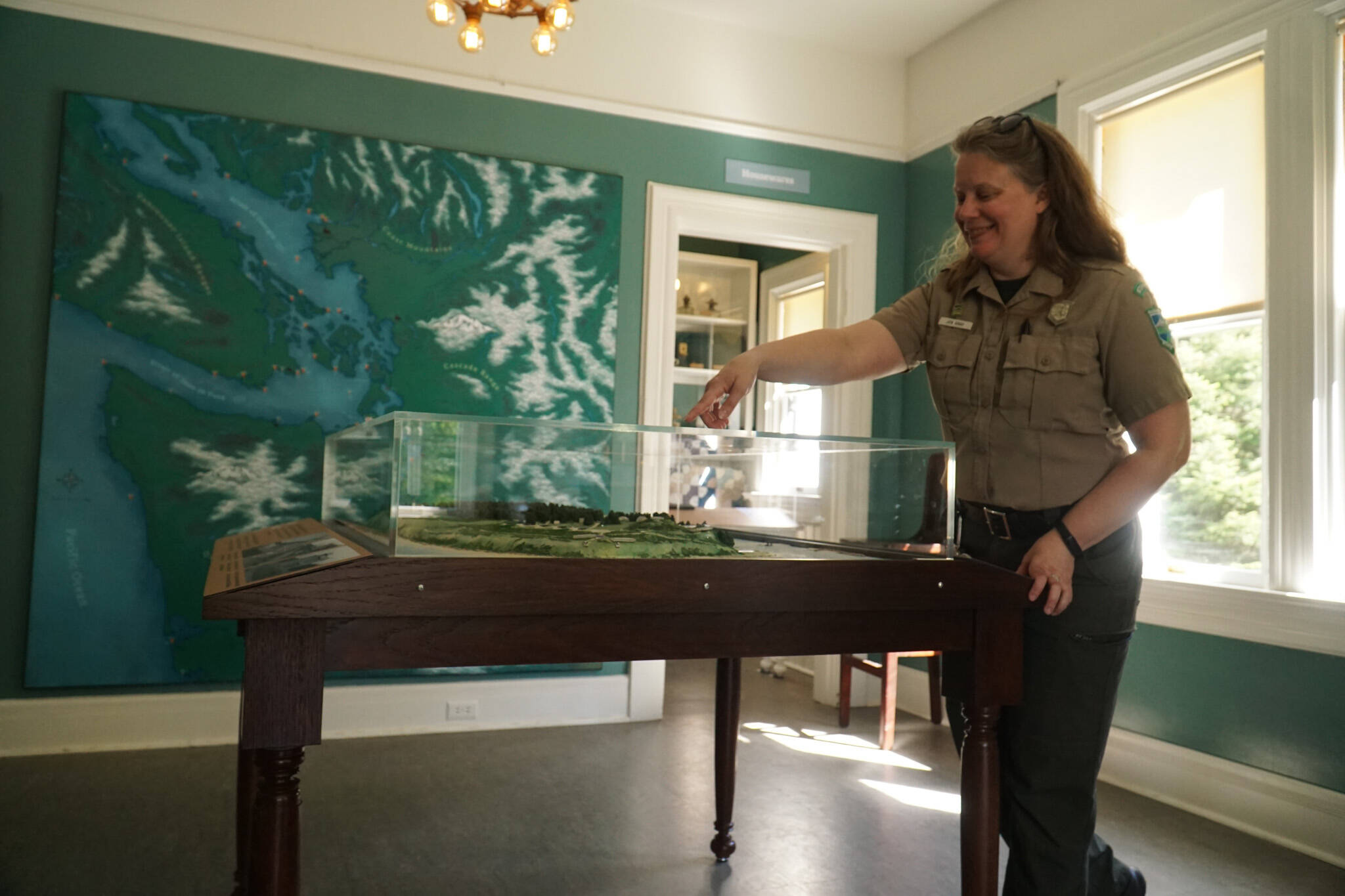 Photo by Sam Fletcher
Interpretive specialist Jen Gray interacts with a Fort Casey map in the new Admiralty Head Lighthouse exhibit.