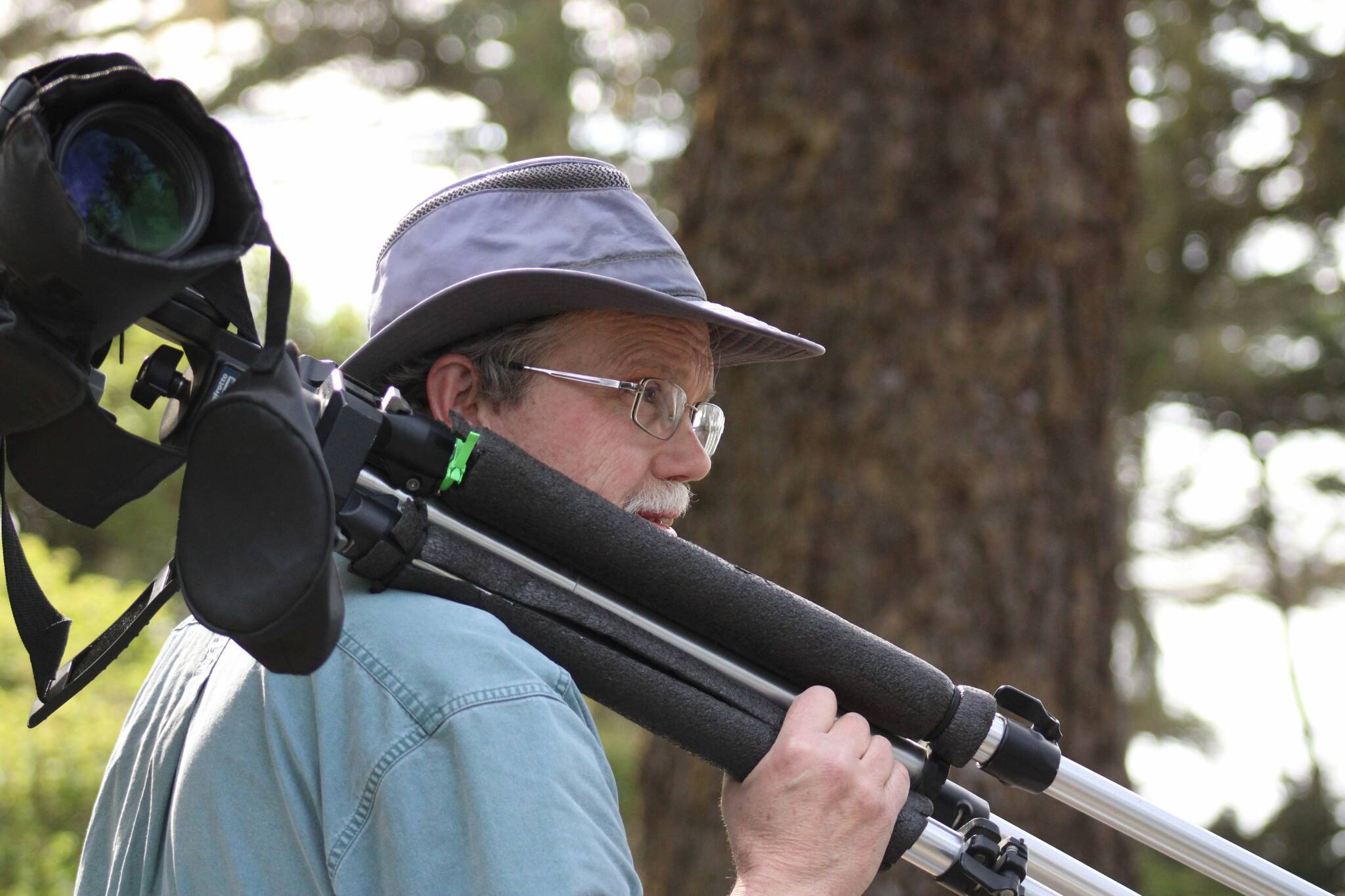 Steven Ellis carries his spotting scope through Fort Ebey State Park. (Photo provided)