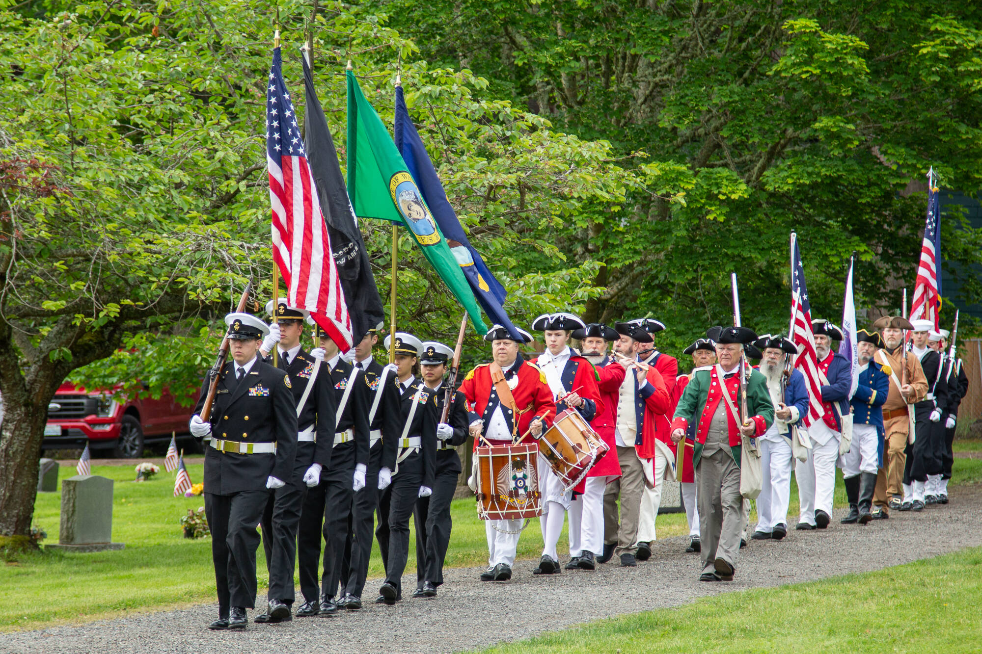 Chief Petty Officer William Thiel, U.S. Navy (Ret); Oak Harbor High School NJROTC Color Guard; Sons of the American Revolution, George Washington Chapter; and the Sea Cadets Corps, Orion Squadron joined the Memorial Day Service of Remembrance at the Maple Leaf Cemetery. (Photo by Caitlyn Anderson)