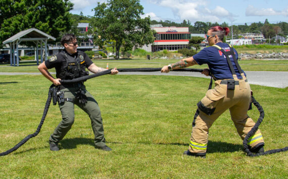 Deputy Sheriff Laurrin Bates (left) and Firefighter Kat Crowe (right) play tug of war in anticipation of the police and firefighter 5k run and tug of war competition, June 12. (Photo by Caitlyn Anderson)