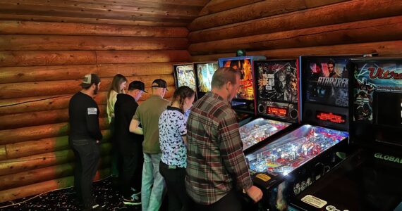 Photo provided
Tossin’ Axes patrons play pinball at Friday’s launch tournament.