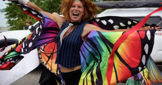 Photo by David Welton
A parade participant from Meander Dance Collective dances down the street at t