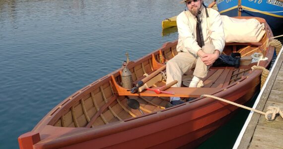 Michael Buse, a history teacher in Olympia, sits in a historical replica boat he built. (Photo provided)