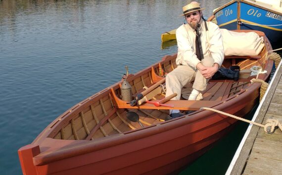 Michael Buse, a history teacher in Olympia, sits in a historical replica boat he built. (Photo provided)