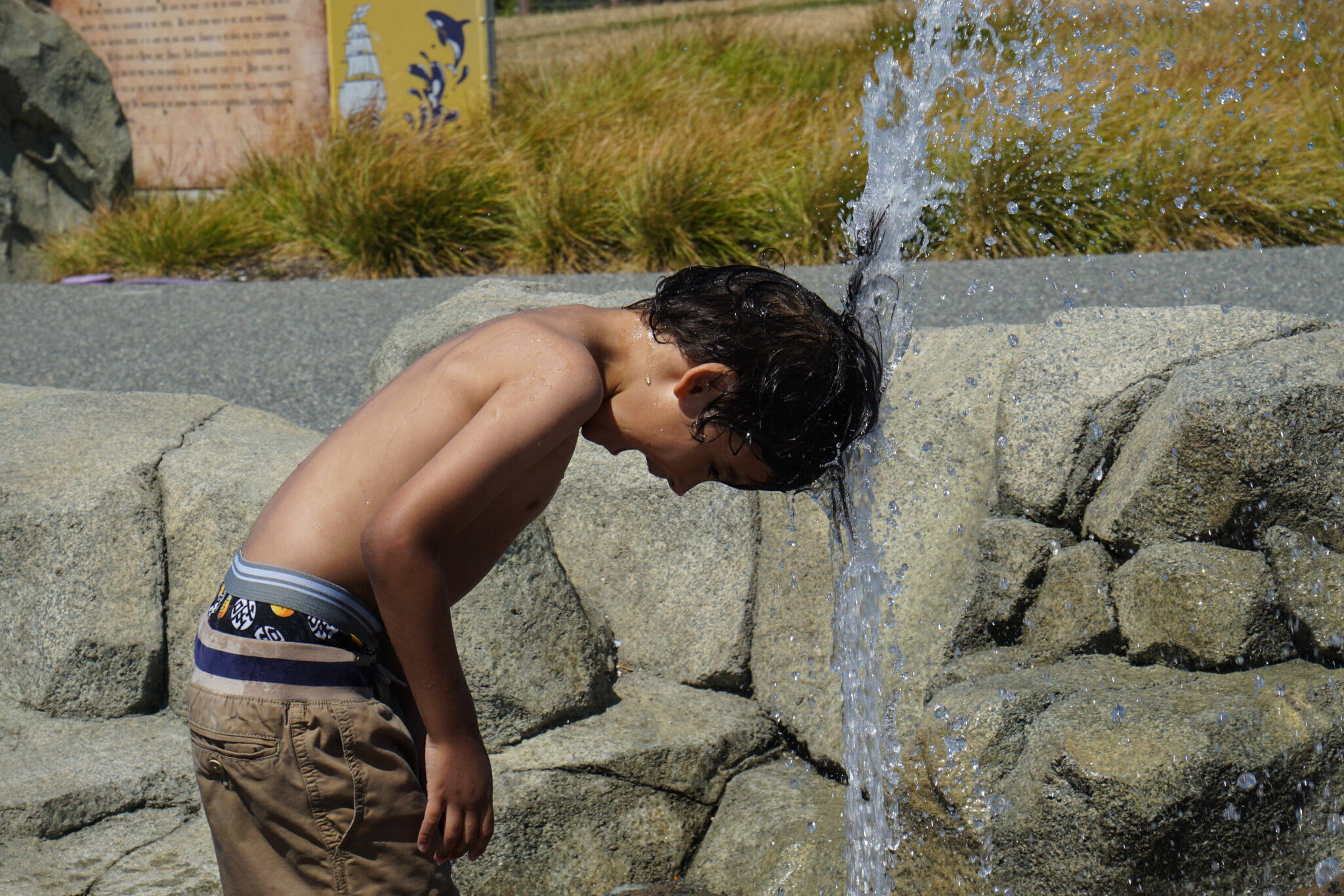 Alex Youngblood plays with a spout at the Splash Park.