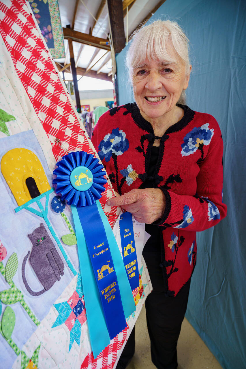 Photo by David Welton
Carole Wagner with her award-winning quilt at the Whidbey Island Fair.