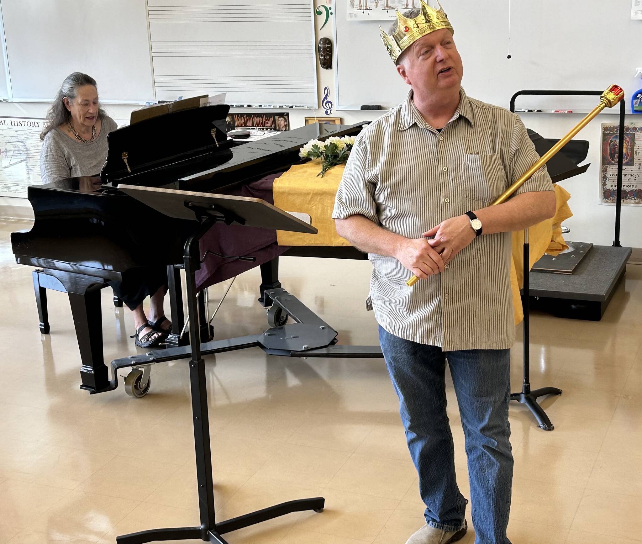 Eileen Soskin plays the piano while singer and actor Ken Merrell dresses up in costume during a rehearsal. (Photo provided)