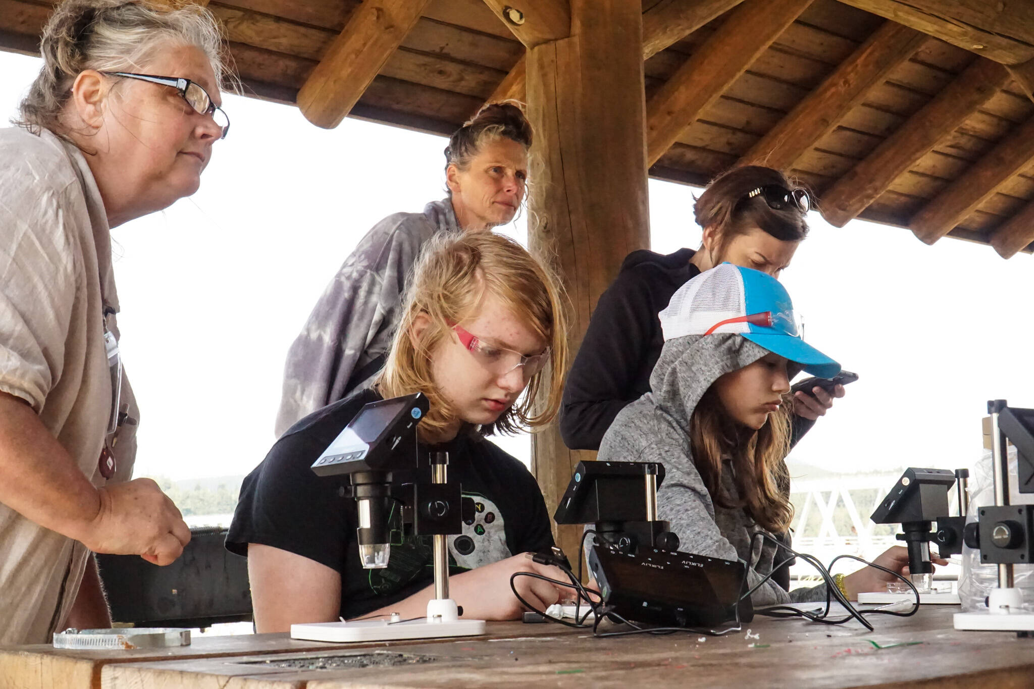 Brenden Vandervort observes plankton he collected with a robot he built in the Atlantis STEAM robotics course. (Photo by Sam Fletcher)