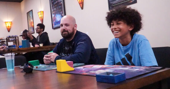 Photo by Sam Fletcher
James O’Boyle, left and Christian Royal play Magic: the Gathering at the Book Rack in Oak Harbor for Friday Night Magic.