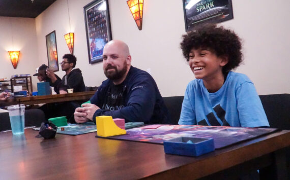 Photo by Sam Fletcher
James O’Boyle, left and Christian Royal play Magic: the Gathering at the Book Rack in Oak Harbor for Friday Night Magic.