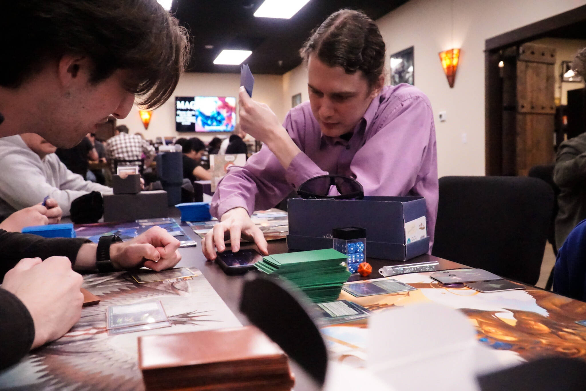 Hudson Harper plays Magic: the Gathering at the Book Rack in Oak Harbor for Friday Night Magic. (Photo by Sam Fletcher)