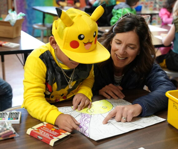 Superintendent Michelle Kuss-Cybula helps a student.