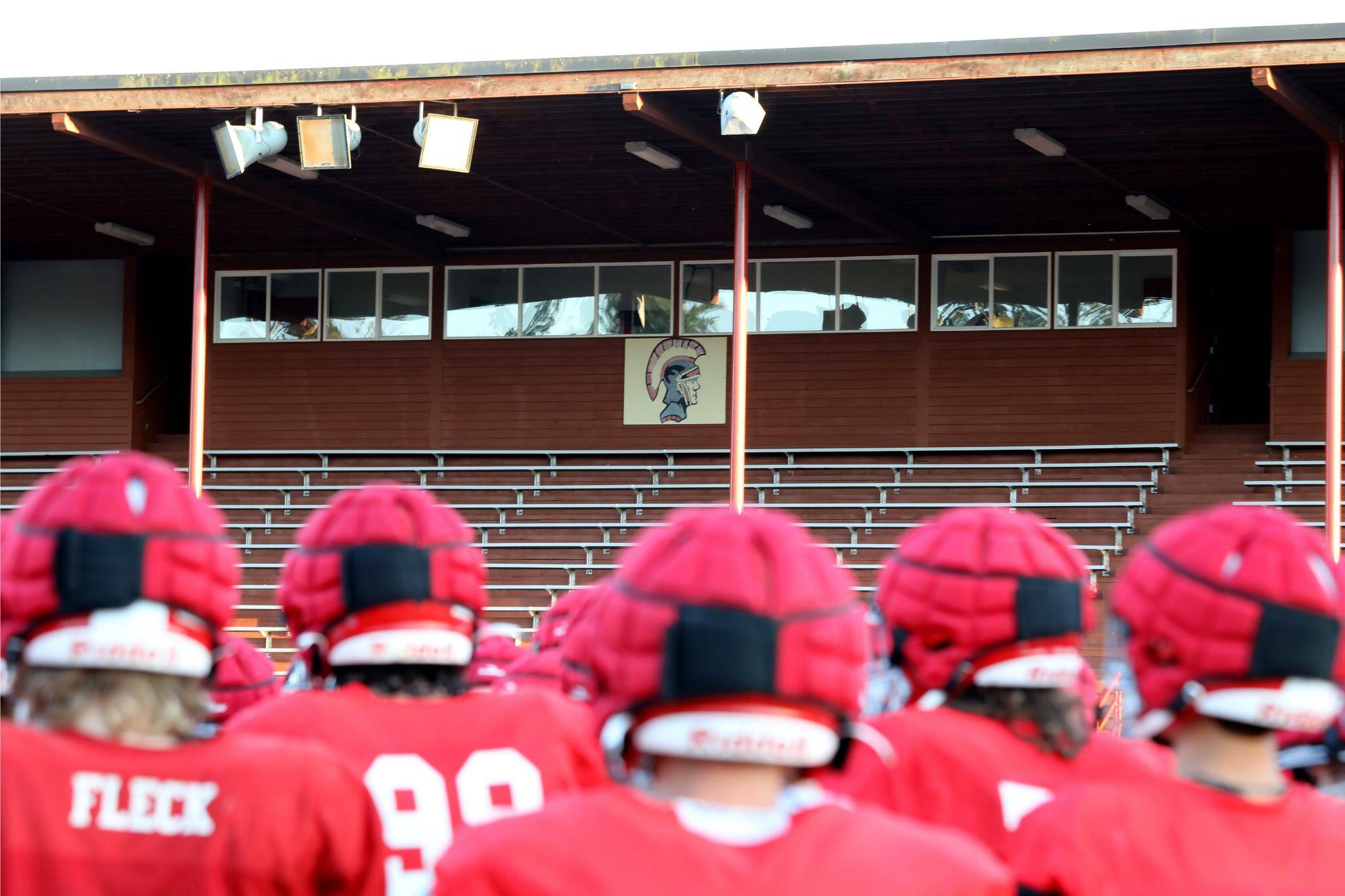 A team photo with the Stanwood High School Spartans logo in the background at Bob Larson Stadium in Stanwood on Aug. 30. (Taras McCurdie / The Herald)