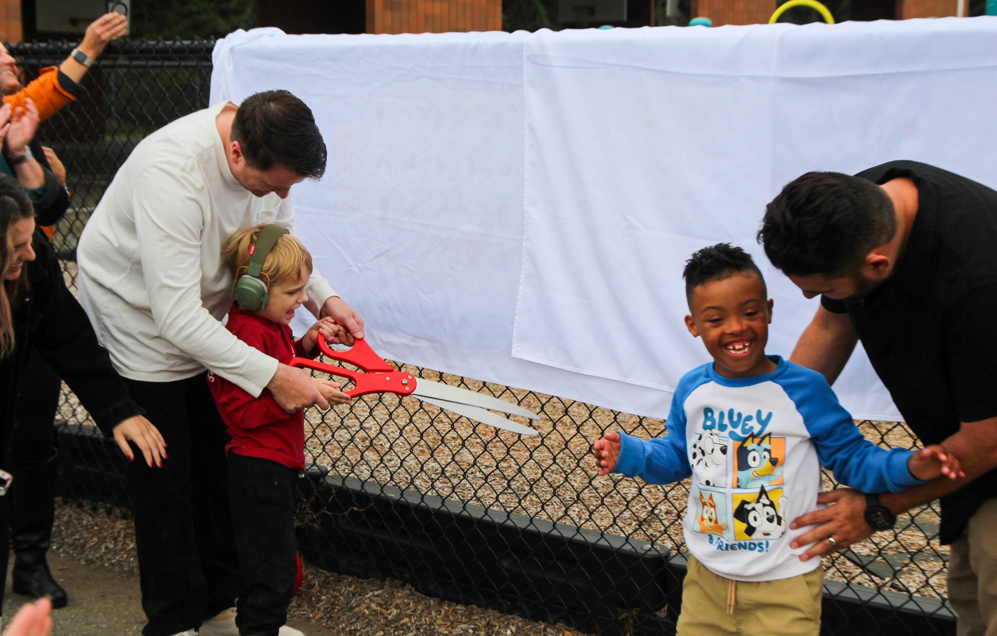 (Photo by Luisa Loi)
Joshua Rube helped his son Emmett cut the ribbon with the assistance of Timothy and Scotty Georgalas.