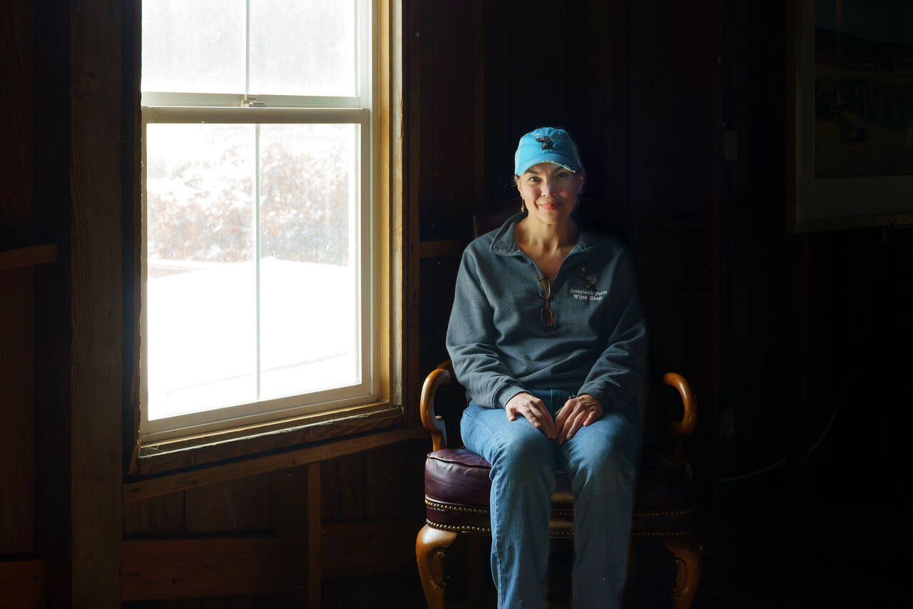 (Photo by David Welton)
Hollie Swanson sits in an antique chair next to the window where an unexplainable shadow was captured on video by ghost hunters last Halloween.