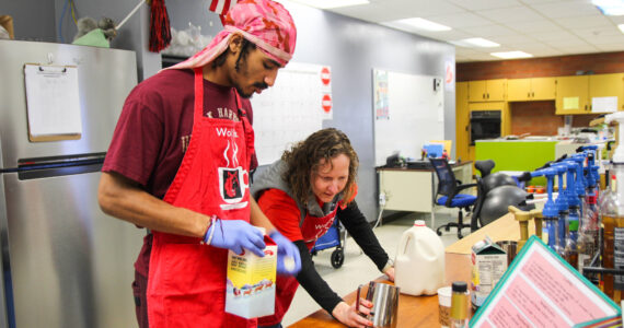 (Photo by Luisa Loi)Transition Specialist Erin Straub assists Nehemiah Myles in making an egg nog latte for a reporter.