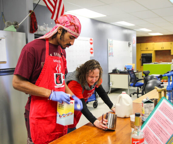 (Photo by Luisa Loi)Transition Specialist Erin Straub assists Nehemiah Myles in making an egg nog latte for a reporter.