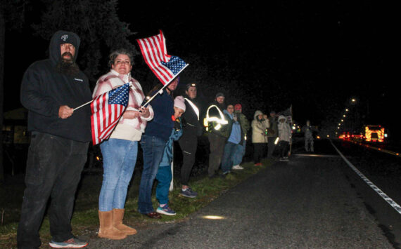 Photo by Sam Fletcher 
Members of the Oak Harbor community show support during the procession of Lt. Serena “Dug” Wileman on Monday.