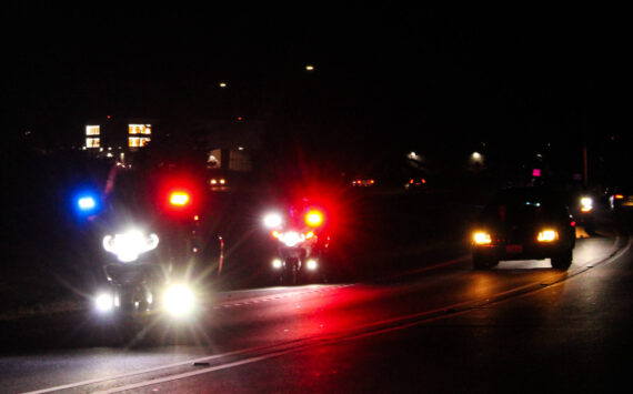 Police escort the hearse carrying Lt. Serena “Dug” Wileman, one of the two aviators lost in the Oct. 15 EA-18G Growler crash during routine training near Mount Rainier, as she returned home from Dover Air Force Base on Monday. (Photo by Sam Fletcher)