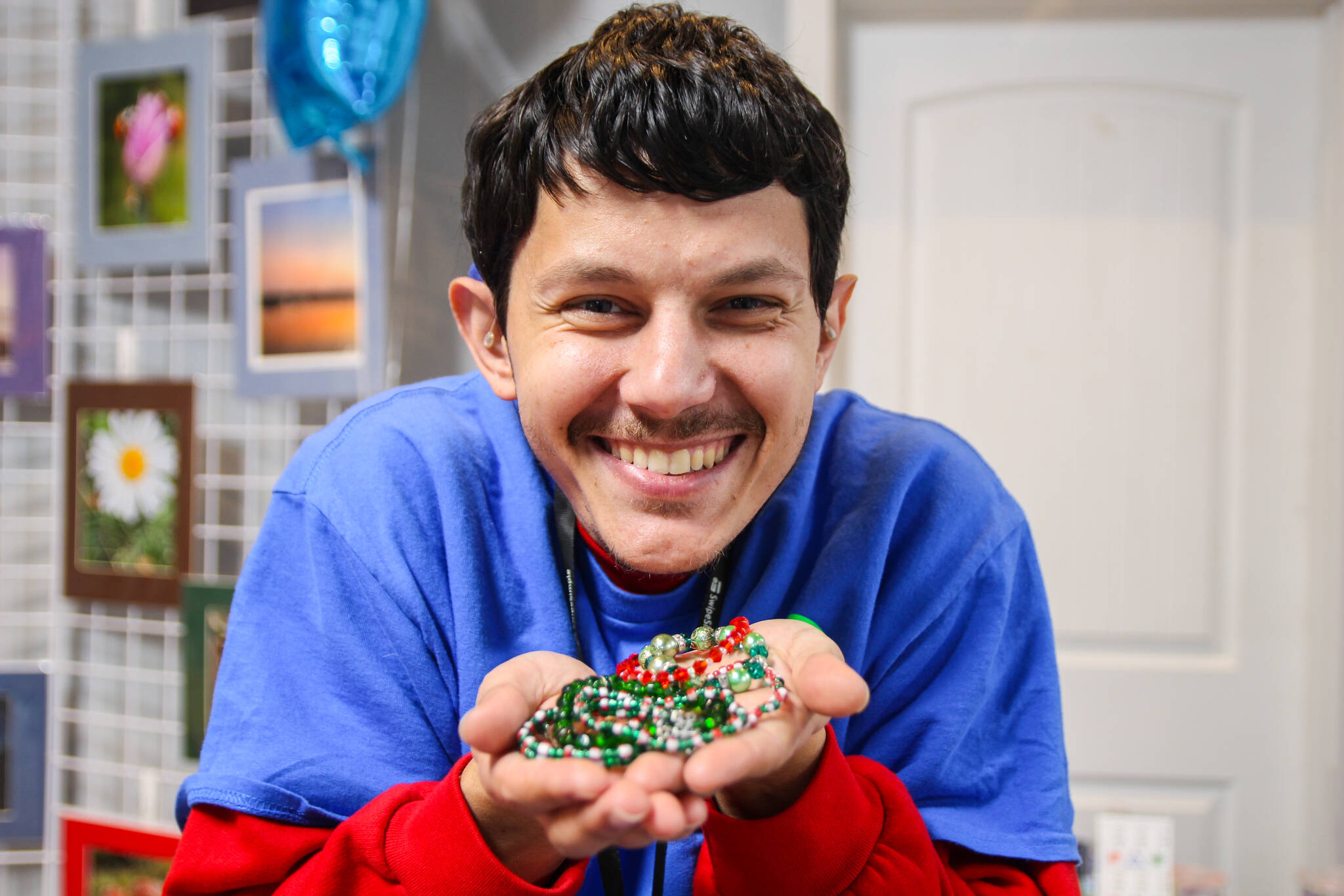 (Photo by Luisa Loi)
Roman holds some of his handmade bracelets.